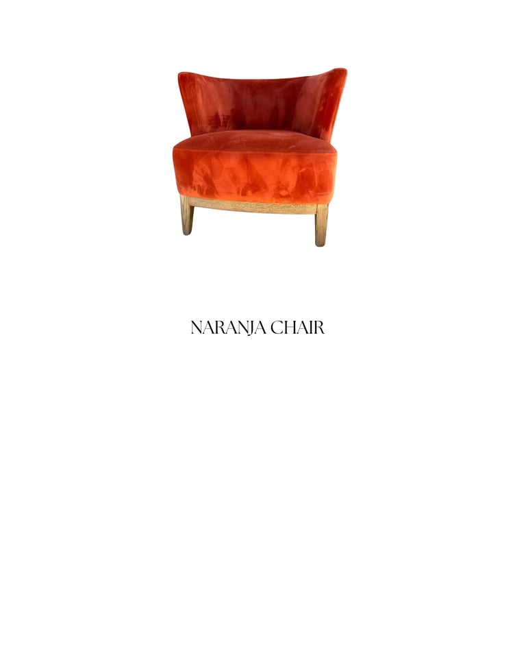 Naranja Chair: A vibrant red-orange velvet armchair with curved wingback design and wooden legs on a white background