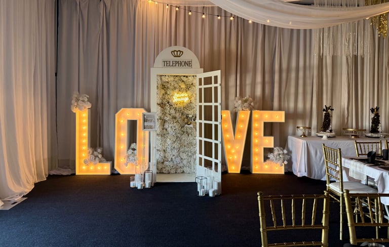 Elegant wedding reception setup with large glowing LOVE letters