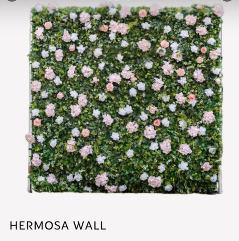 Hermosa Wall featuring a green living wall covered with pink and white flowers blooming throughout dense foliage