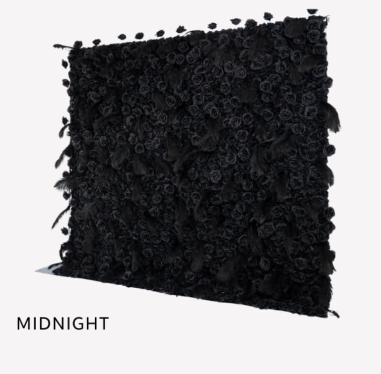 Black decorative pillow with textured rose pattern and tasseled edges labeled Midnight