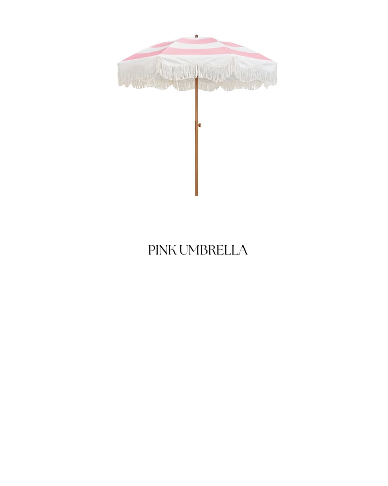 Pink and white striped beach umbrella with fringe trim and wooden pole labeled Pink Umbrella