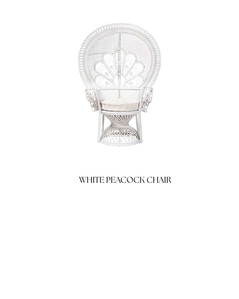 White woven wicker peacock chair with high curved fan-shaped backrest and cream cushion seat